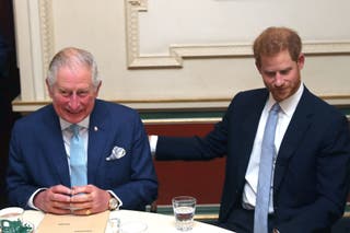 Charles and Harry sit together during a discussion about violent youth crime at a forum held at Clarence House in London