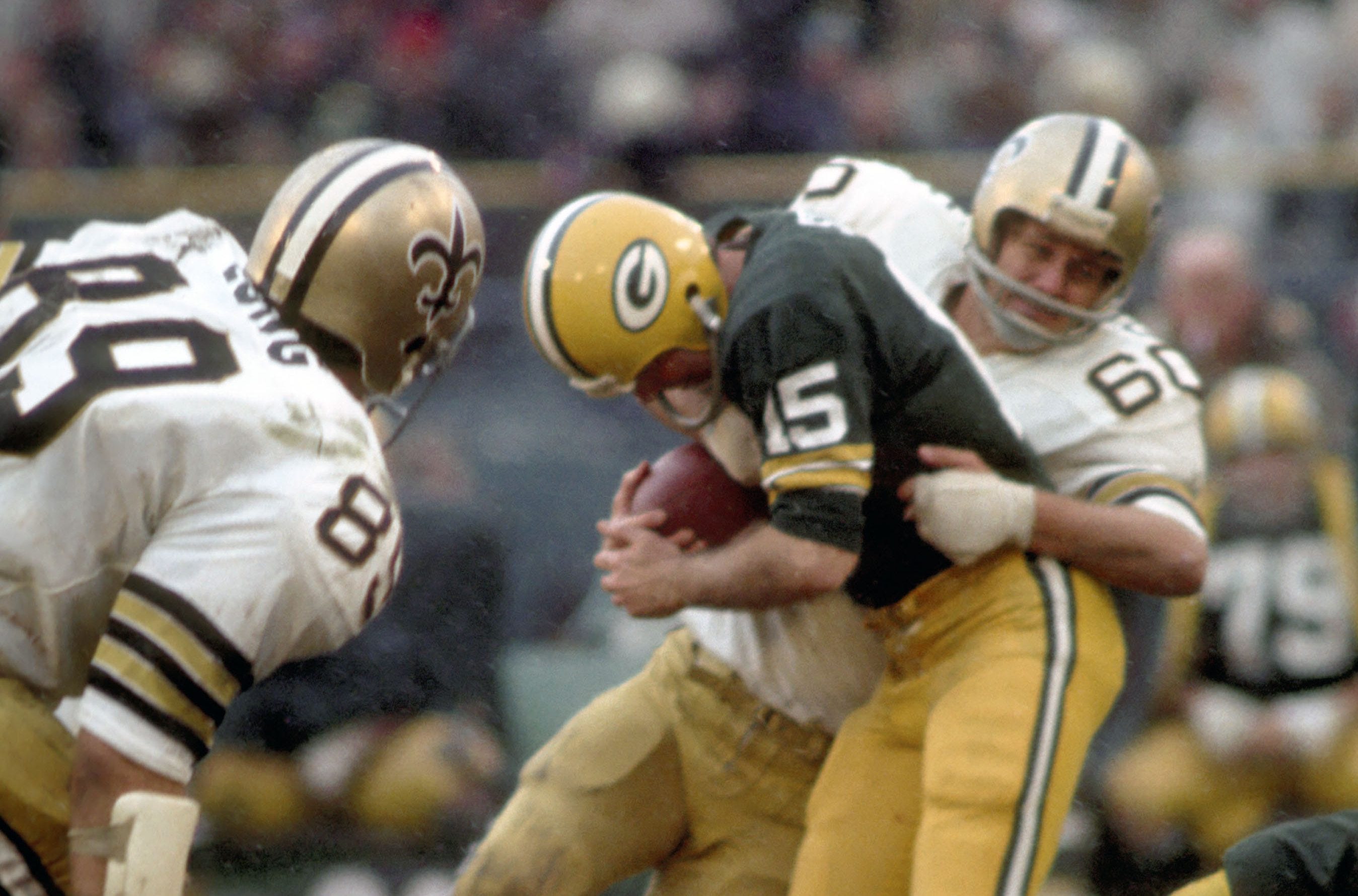 Nov 28, 1971; Milwaukee, WI, USA; FILE PHOTO; New Orleans Saints linebacker Carl Cunningham (60) sacks Green Bay Packers quarterback Bart Starr (15) at Milwaukee County Stadium. Mandatory Credit: Malcolm Emmons-USA TODAY Sports