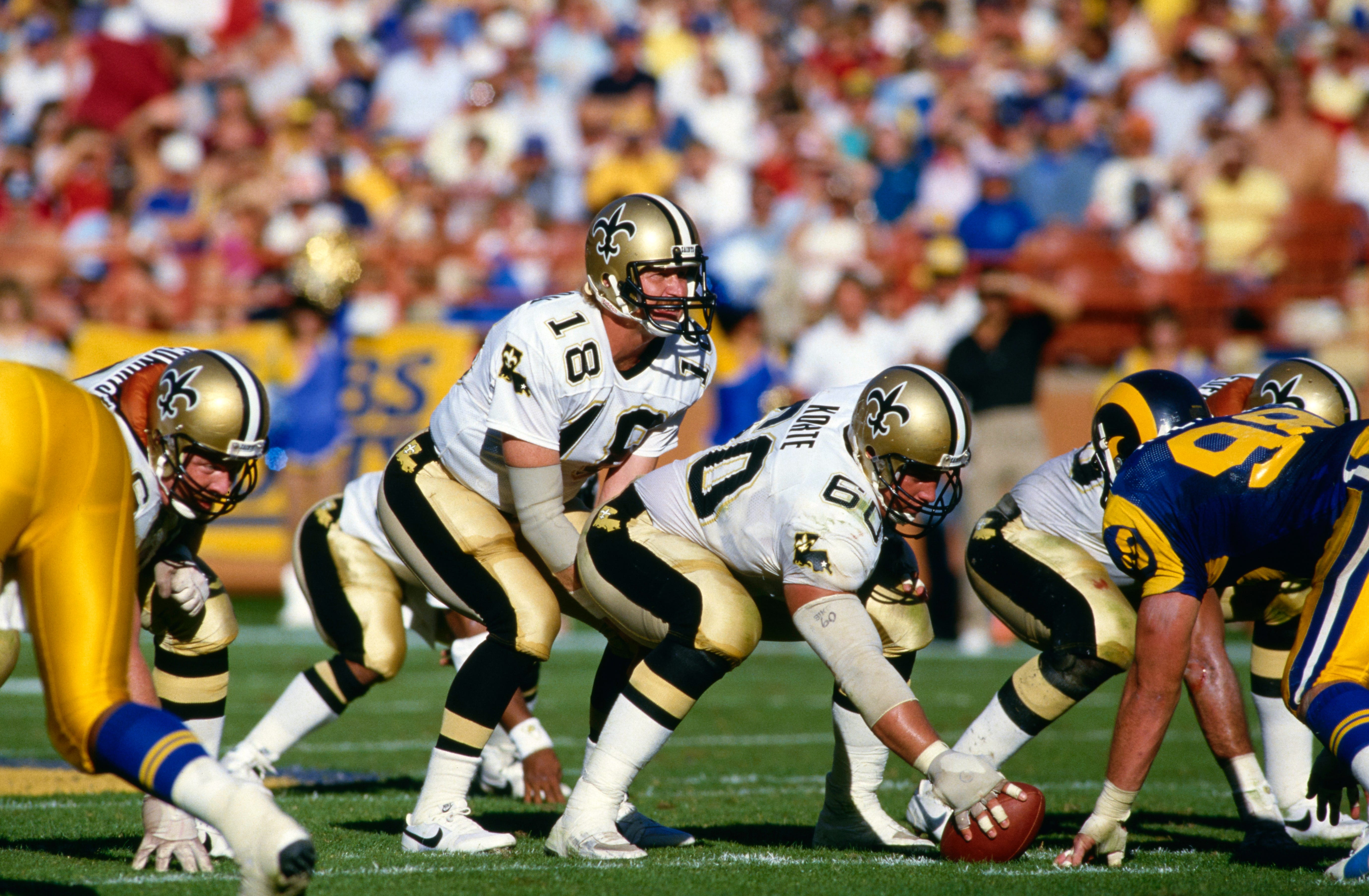 Dave Wilson #18, Quarterback for the New Orleans Saints calls the play on the line of scrimmage as Center #60 Steve Korte readies to snap the football during the National Football Conference West game against the Los Angeles Rams on 3rd November 1985 at the Anaheim Stadium, Anaheim, California, United States. The Los Angeles Rams won the game 28 - 10. (Photo by Tony Duffy/Allsport/Getty Images)