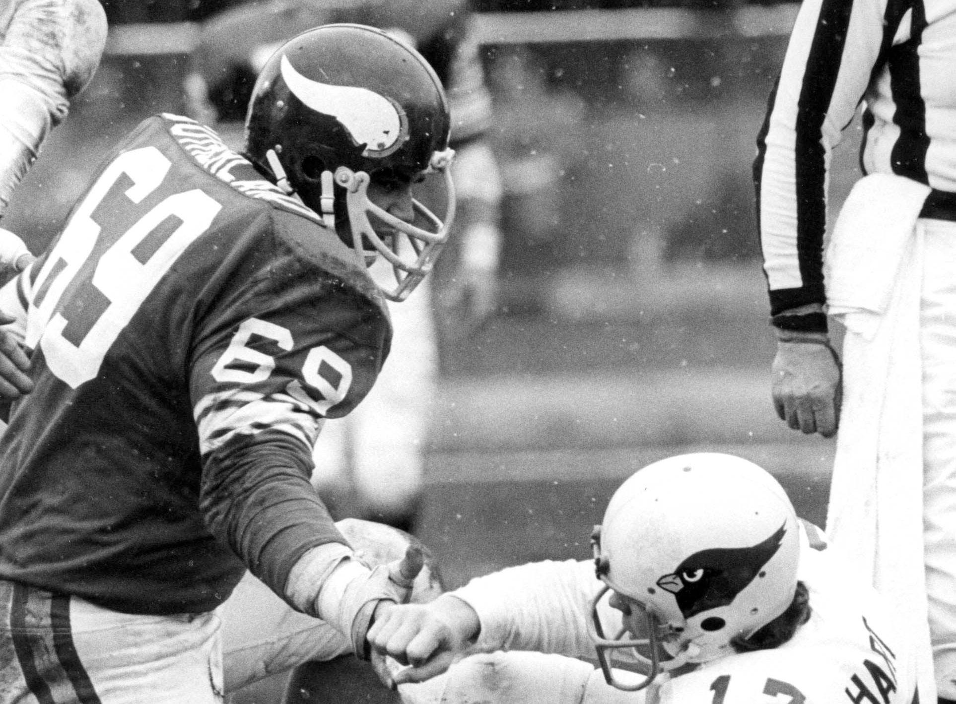 Dec 21, 1974; Bloomington, MN, USA; FILE PHOTO; Minnesota Vikings defensive tackle Doug Sutherland (69) offers St.Louis Cardinals quarterback Jim Hart (17) a hand during NFC Divisional Playoff game at Metropolitan Stadium. The Vikings defeated the Cardinals 30-14. Mandatory Credit: Dick Raphael-USA TODAY Sports