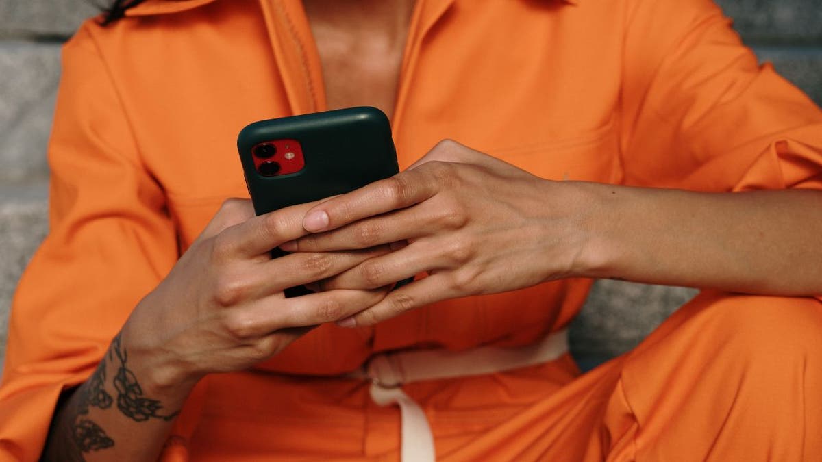 Woman on her phone while sitting down.